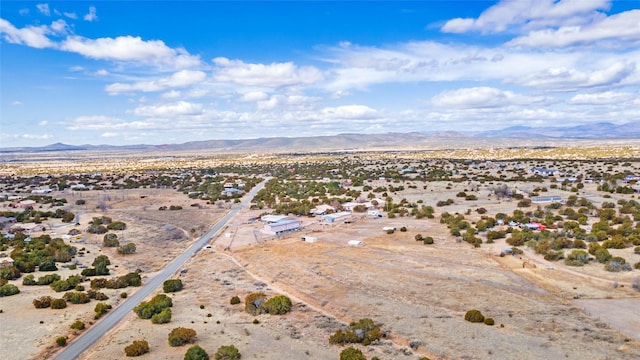 birds eye view of property featuring a mountain view and a desert view