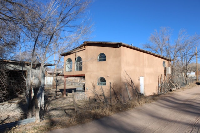 back of house with stucco siding