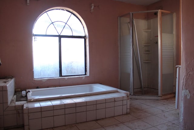 full bath featuring a bath, tile patterned flooring, and a shower stall