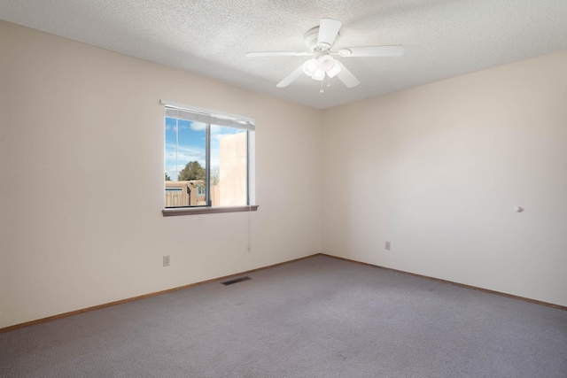 spare room with visible vents, a textured ceiling, ceiling fan, and carpet flooring