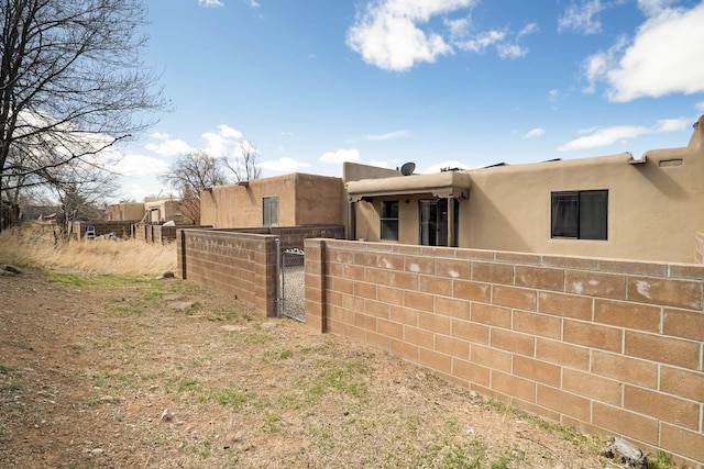 exterior space featuring a gate and fence