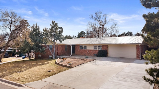 ranch-style home with brick siding, driveway, and a garage