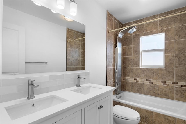 full bath featuring tiled shower / bath combo, toilet, tasteful backsplash, and a sink