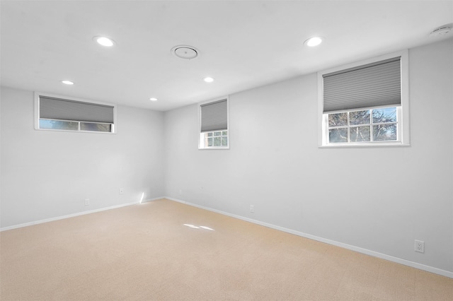 below grade area with recessed lighting, baseboards, and light colored carpet