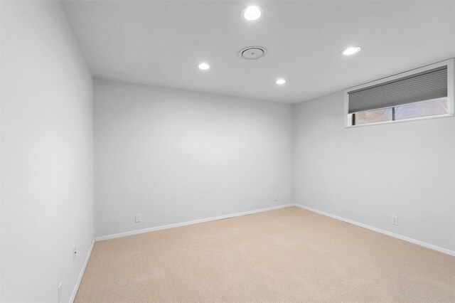 basement featuring recessed lighting, baseboards, and carpet