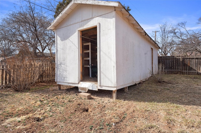 view of shed featuring fence