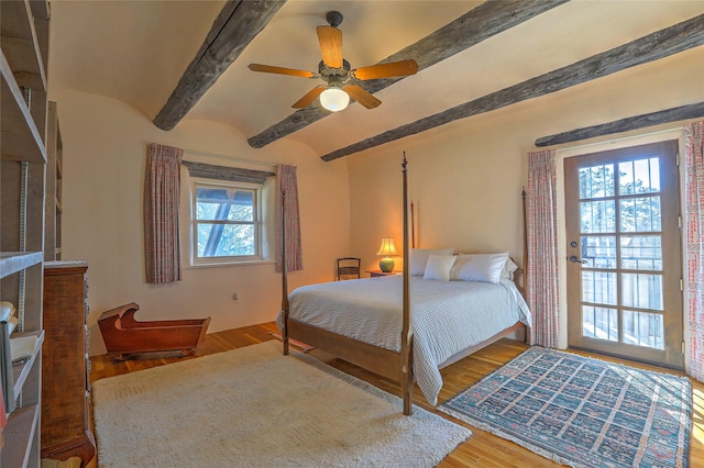 bedroom featuring a ceiling fan, beamed ceiling, and wood finished floors