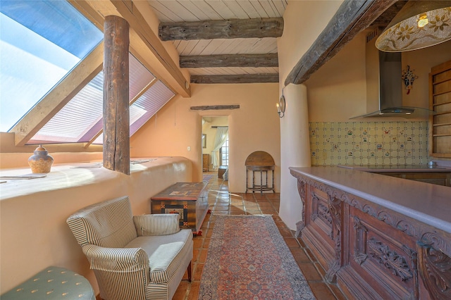 sitting room with wood ceiling and vaulted ceiling with beams