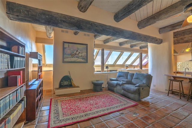 living room with beamed ceiling and visible vents