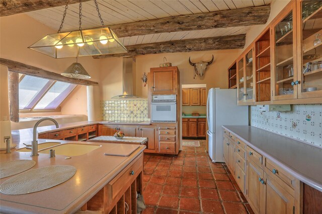 kitchen featuring white appliances, a sink, wooden ceiling, wall chimney range hood, and backsplash