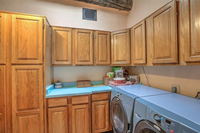 laundry room with visible vents, cabinet space, and independent washer and dryer