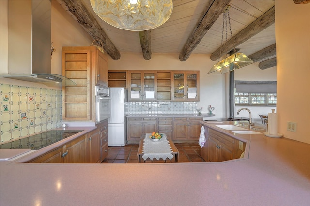 kitchen with a sink, freestanding refrigerator, wall chimney range hood, stainless steel oven, and black electric stovetop