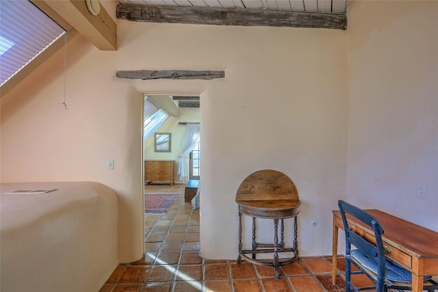 interior space with lofted ceiling with beams