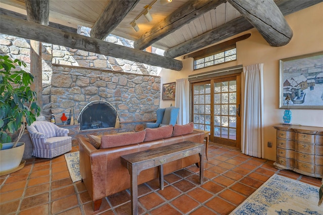 living room with beamed ceiling, wooden ceiling, a fireplace, rail lighting, and tile patterned floors