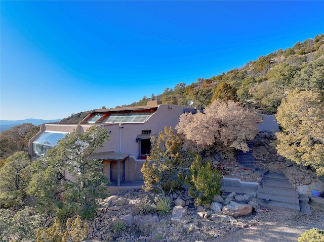 back of house featuring stucco siding