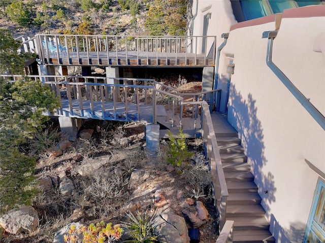 exterior space with stucco siding and stairs