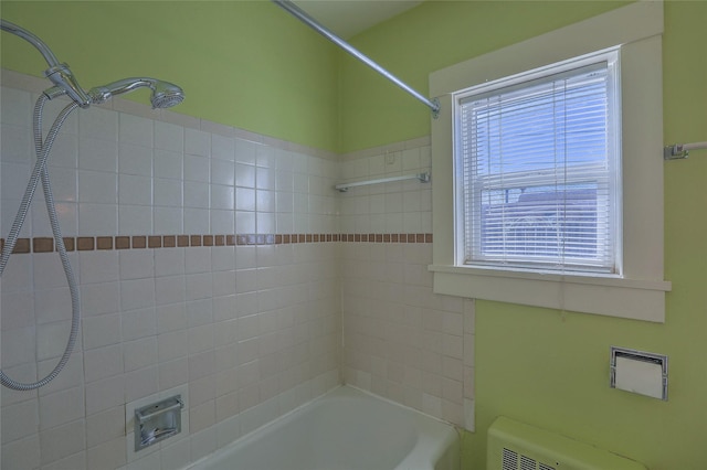 bathroom with shower / bathing tub combination and radiator heating unit