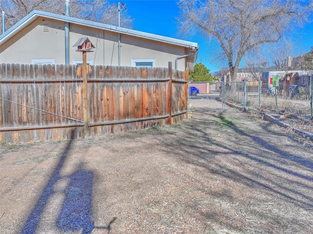 view of side of property featuring fence and stucco siding