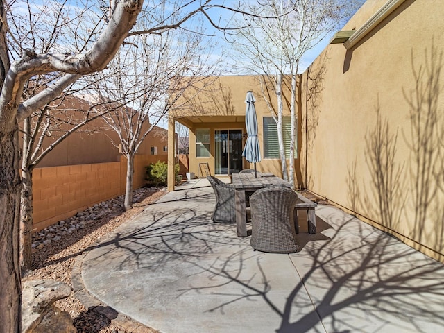 view of patio featuring fence