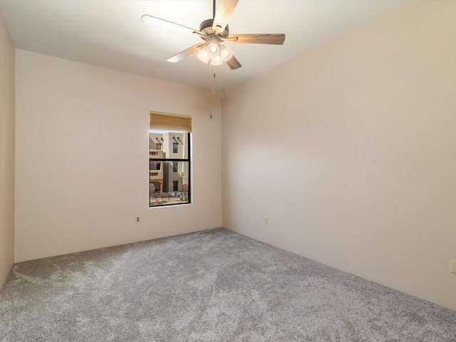 empty room featuring carpet flooring and a ceiling fan