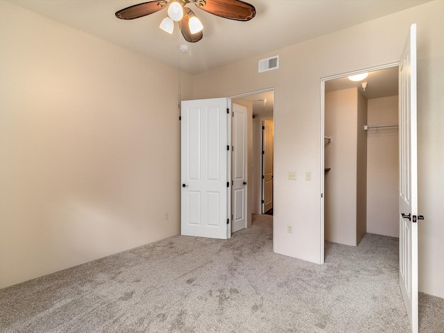 unfurnished bedroom featuring a closet, visible vents, ceiling fan, and carpet floors