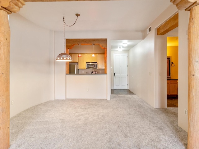 unfurnished living room with carpet flooring and visible vents