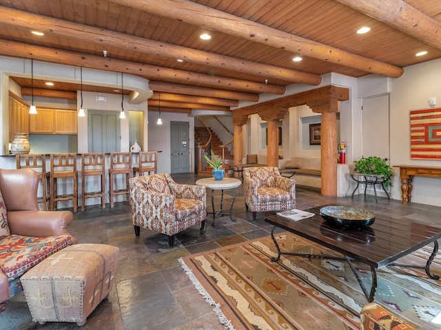 living room featuring beam ceiling, recessed lighting, stone tile flooring, stairs, and wooden ceiling