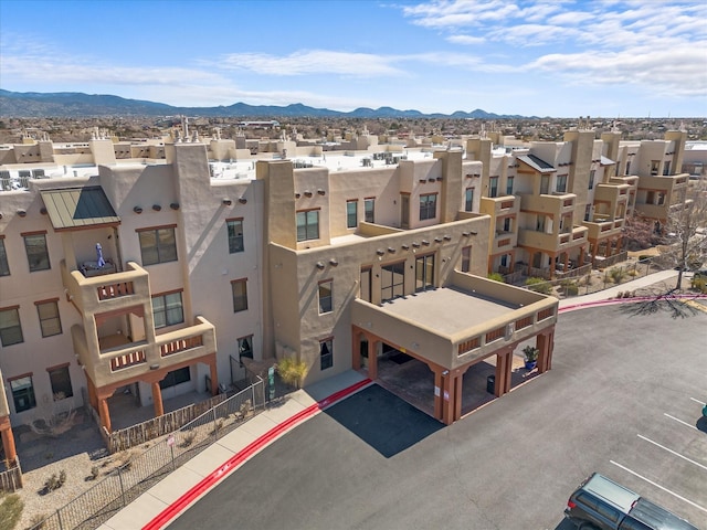 drone / aerial view featuring a residential view and a mountain view