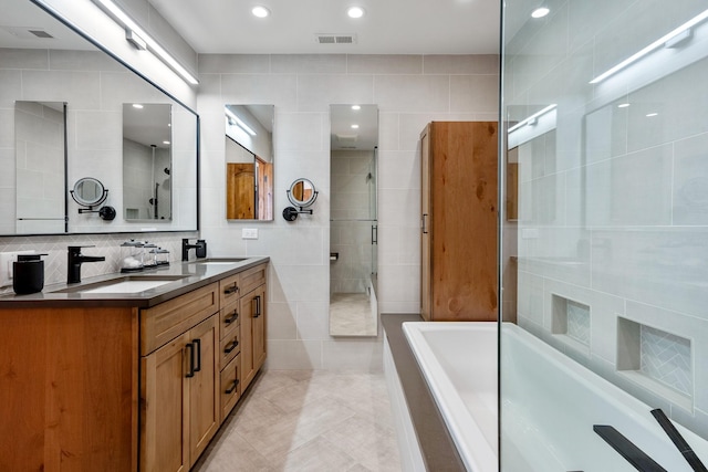 full bath featuring a sink, tile walls, and a shower stall