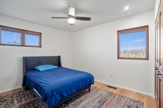 bedroom featuring visible vents, recessed lighting, light wood-style floors, baseboards, and ceiling fan