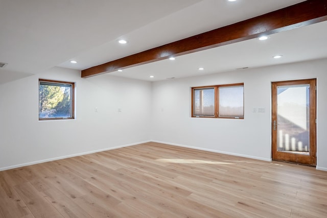 unfurnished room with beamed ceiling, visible vents, recessed lighting, light wood finished floors, and baseboards