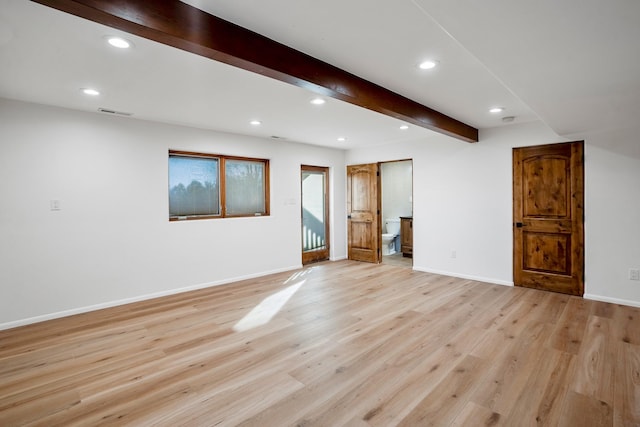 empty room featuring baseboards, visible vents, beam ceiling, light wood-style flooring, and recessed lighting