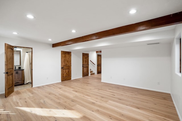 interior space featuring recessed lighting, baseboards, beam ceiling, and light wood finished floors