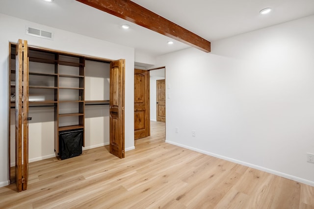 unfurnished bedroom featuring light wood finished floors, visible vents, baseboards, beamed ceiling, and recessed lighting