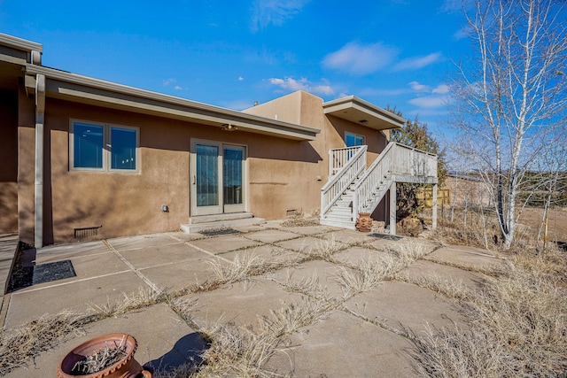 back of house with a wooden deck, stairway, a patio area, and stucco siding