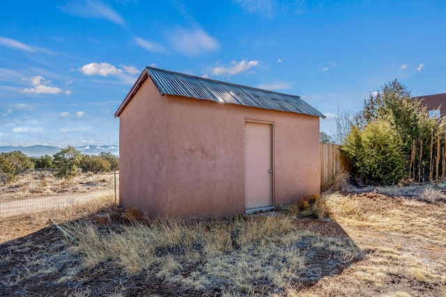 view of shed featuring fence