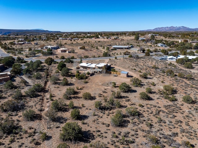 birds eye view of property featuring a mountain view and a desert view