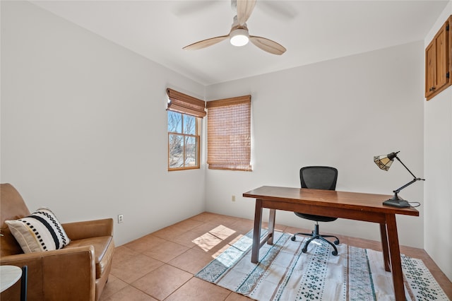 office area with light tile patterned floors and a ceiling fan