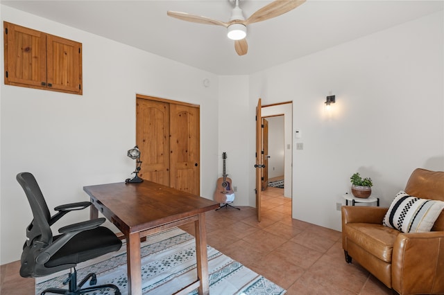 office space with light tile patterned floors and a ceiling fan