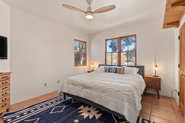 bedroom with light tile patterned floors and ceiling fan