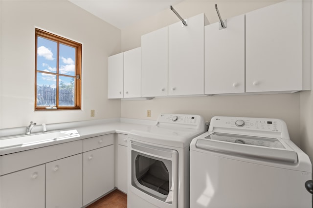 laundry area featuring a sink, cabinet space, and washing machine and clothes dryer