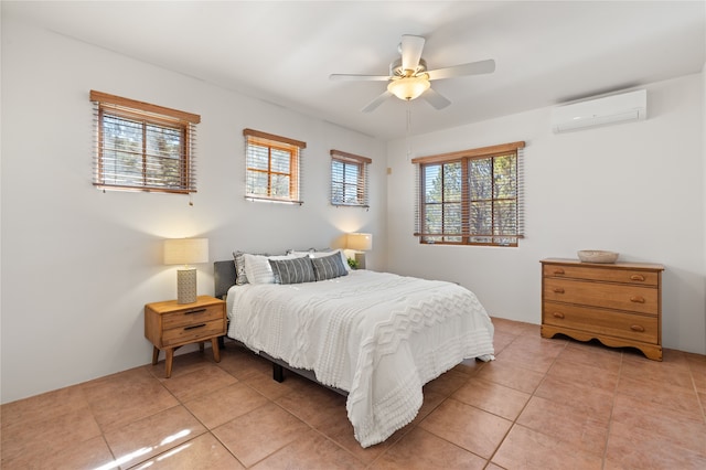 bedroom featuring an AC wall unit, light tile patterned flooring, and a ceiling fan