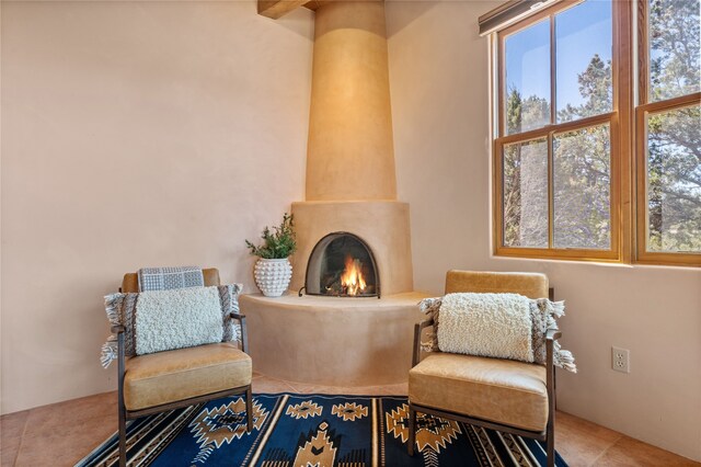 sitting room with tile patterned floors and a fireplace