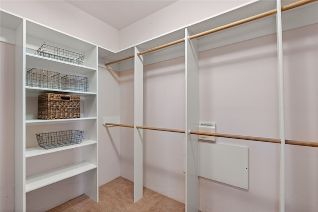 spacious closet featuring tile patterned flooring