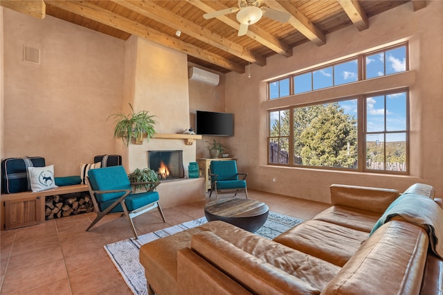 tiled living area featuring beam ceiling, wood ceiling, a wall mounted air conditioner, and a lit fireplace