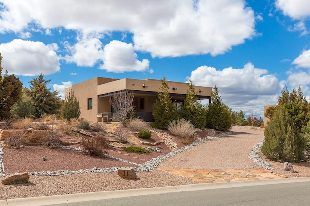 pueblo-style house with stucco siding