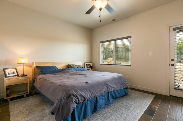 bedroom featuring visible vents, ceiling fan, baseboards, and wood tiled floor