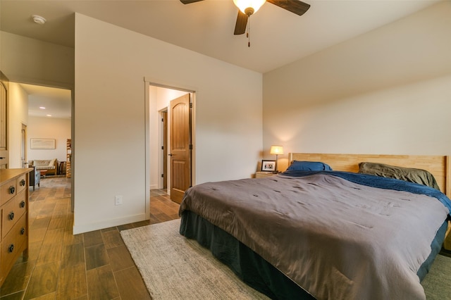 bedroom with dark wood finished floors and baseboards