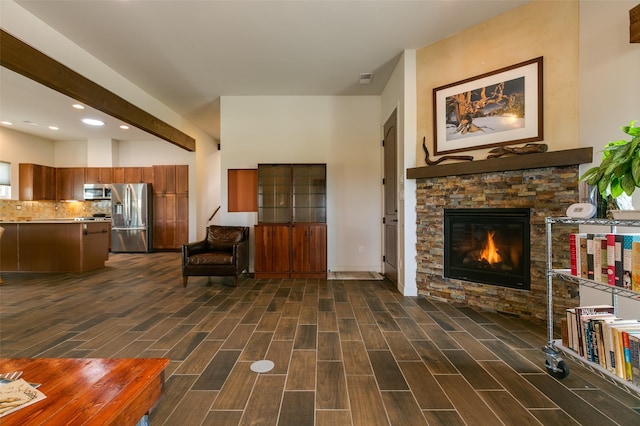 living room with a stone fireplace, recessed lighting, and wood finish floors