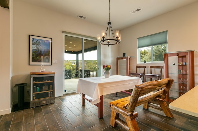 dining space featuring wine cooler, visible vents, plenty of natural light, and wood finish floors